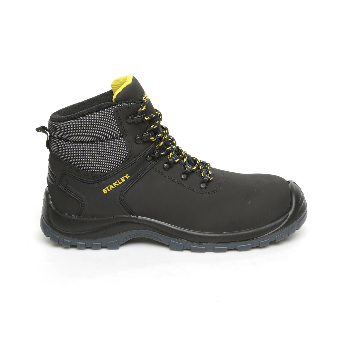 Black work boot with yellow accents on a white background