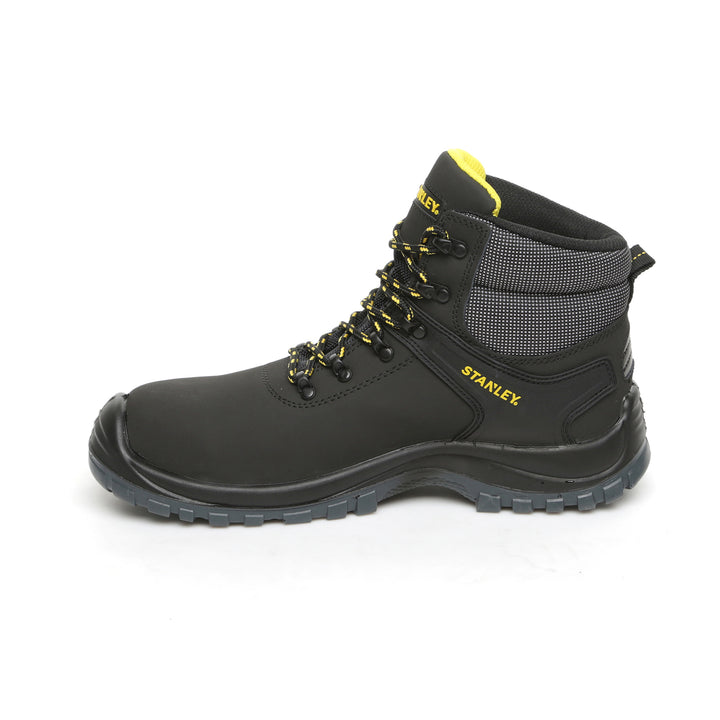 Black work boot with yellow accents on a white background