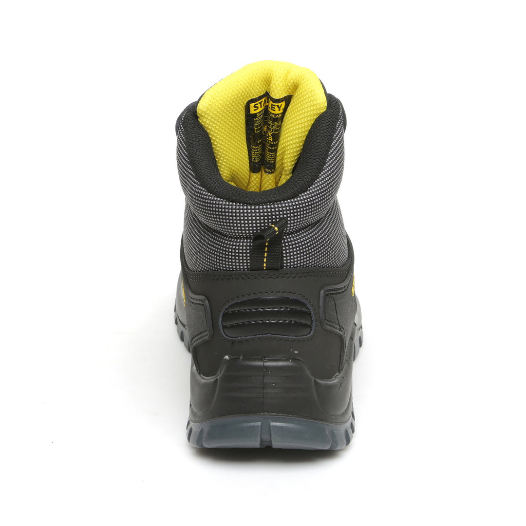 Black and gray boot with yellow lining on a white background