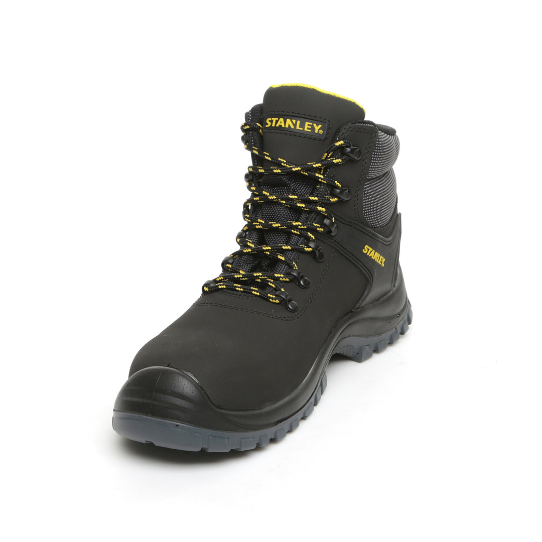 Black work boot with yellow laces and Stanley logo on a white background